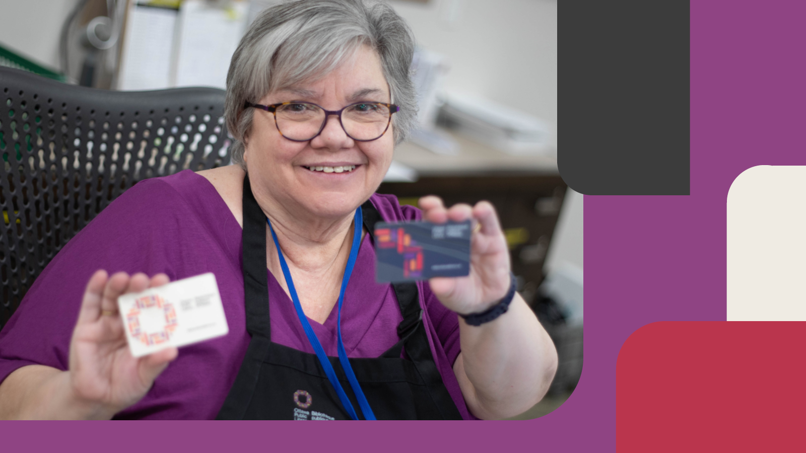 Librarian holding two new branded library cards